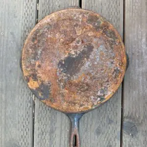 Old frying pan with rust spots.