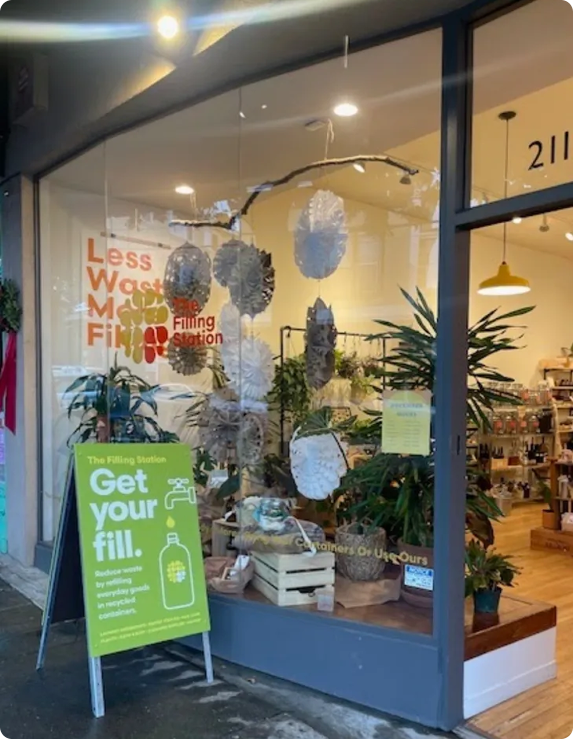 Eco-conscious storefront with plants and signage