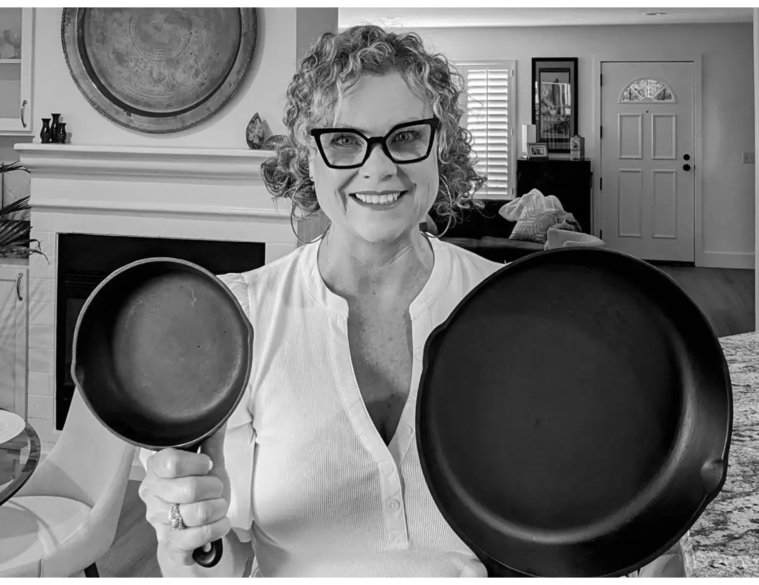 Woman holding two different frying pans