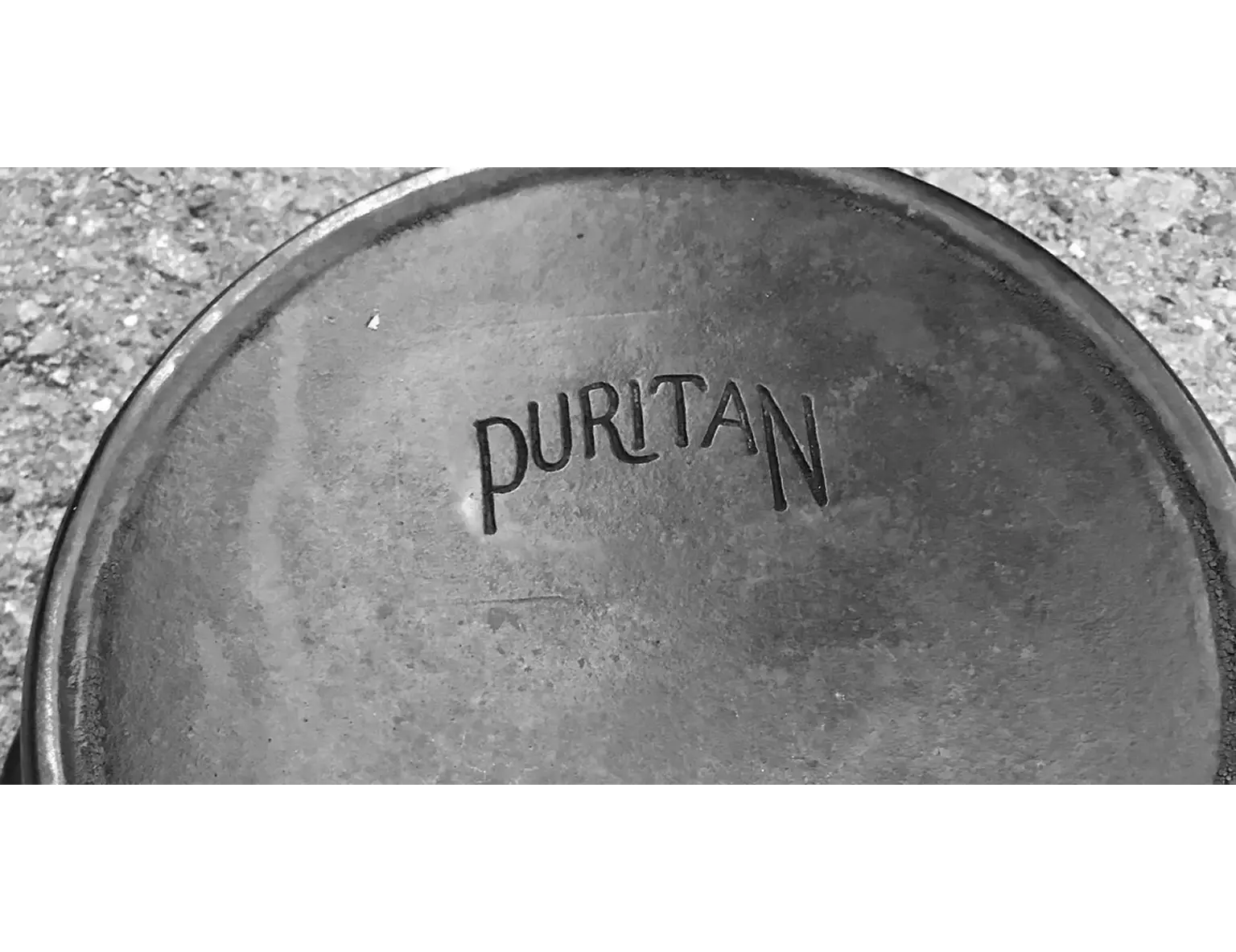 Puritan logo on cast iron surface