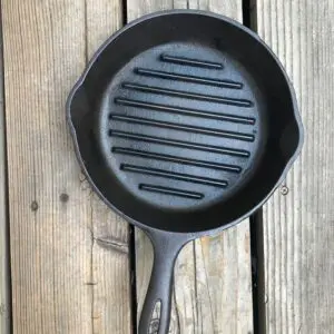 Empty skillet on rustic wood background