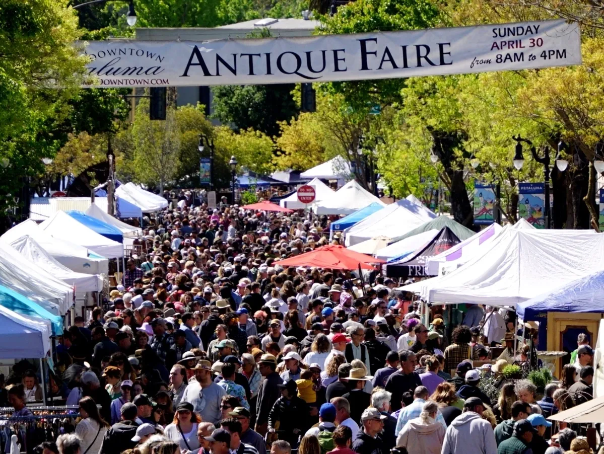 Crowded antique fair with vendor tents
