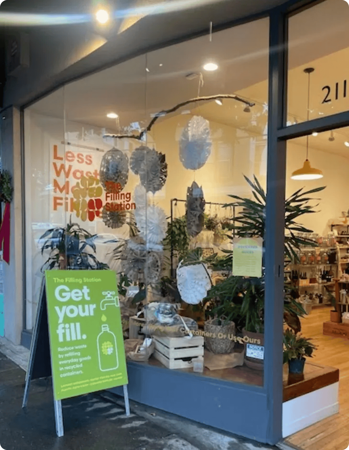 Eco-conscious storefront with plants and signage