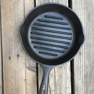 Empty skillet on rustic wood background